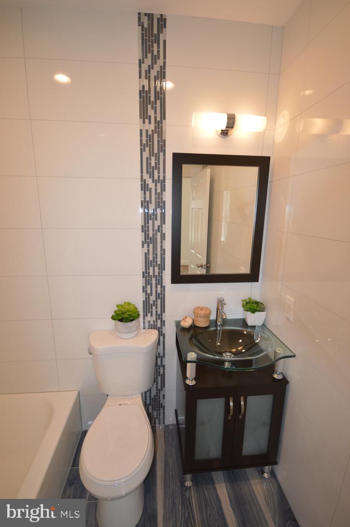 1827 Dudley Street Philadelphia, PA 19145 - Photo 10 of 15 a bathroom with a toilet sink and mirror