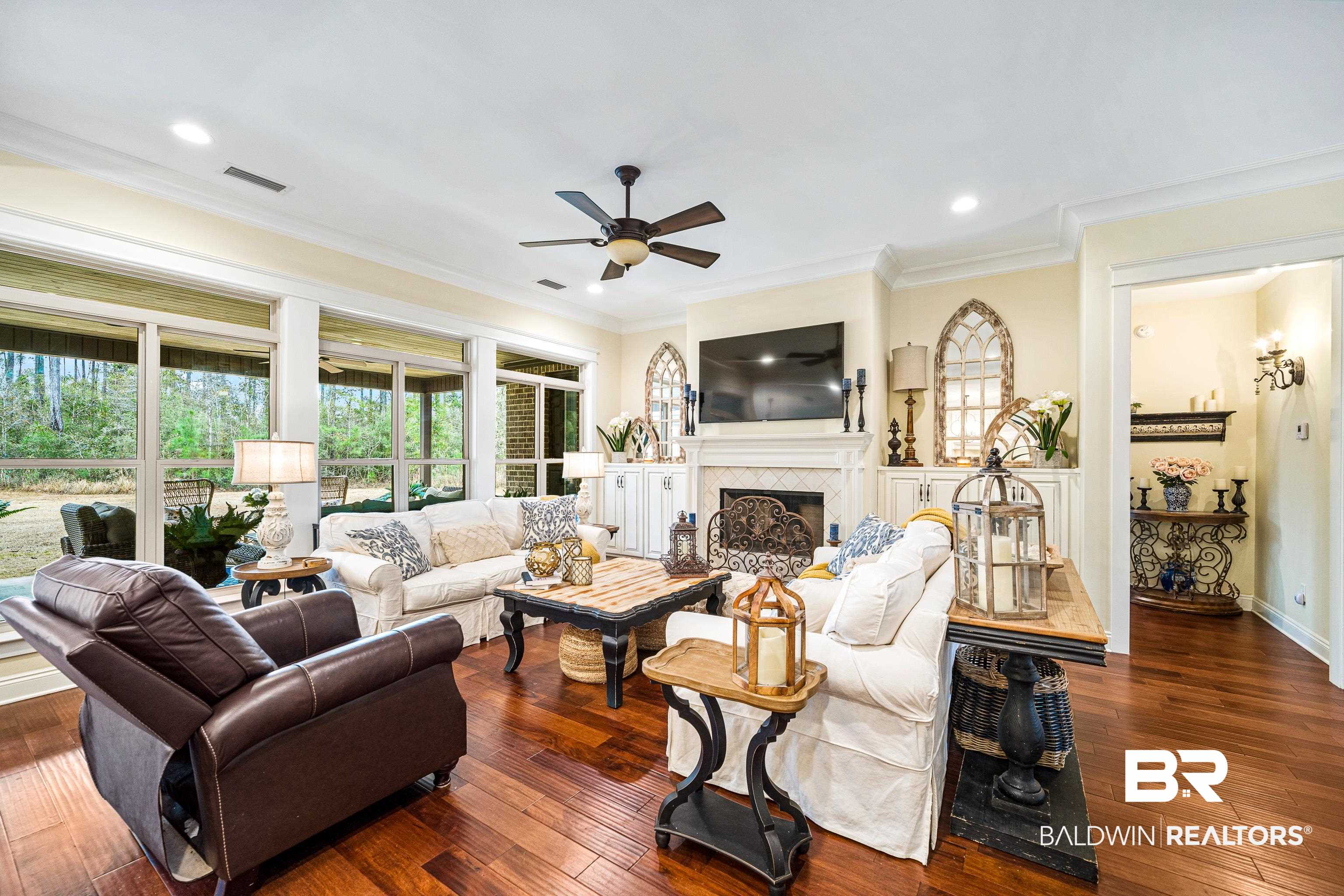 36784 Legacy Way Bay Minette, AL 36507 - Photo 9 of 57 Living room with crown molding, ceiling fan, and dark hardwood / wood-style flooring