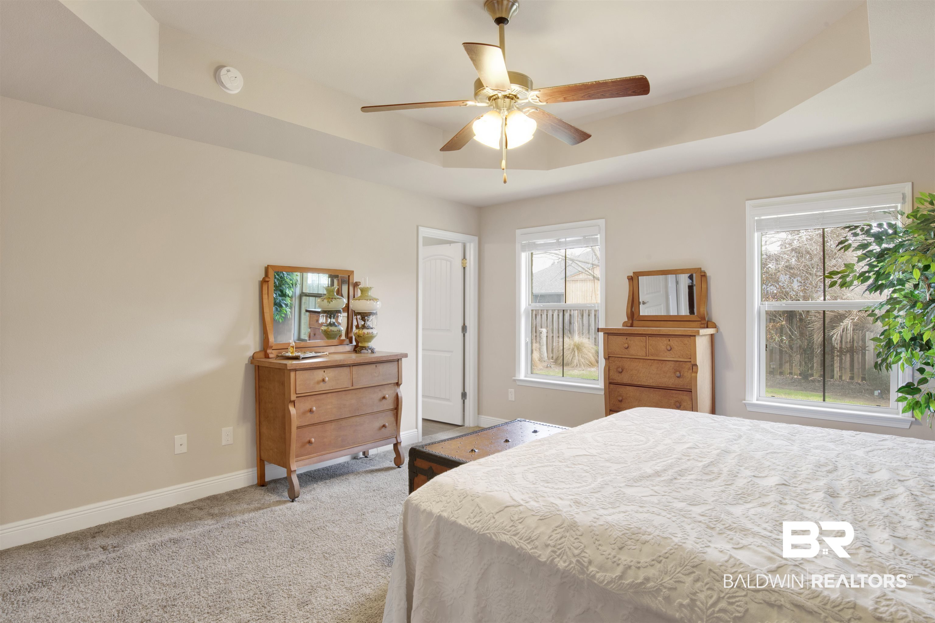 22056 Garland Loop Silverhill, AL 36576 - Photo 14 of 28 Carpeted bedroom featuring baseboards, a ceiling fan, and a raised ceiling