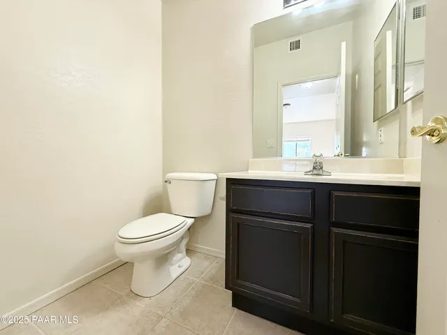 a bathroom with a sink toilet and mirror