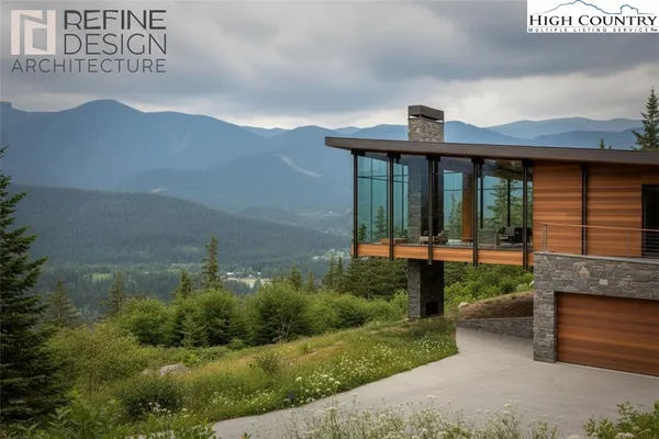 a front view of a house with a yard and mountain view