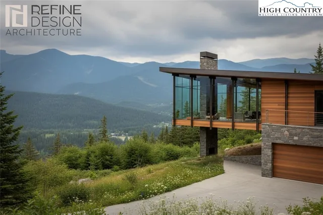 a front view of a house with a yard and mountain view