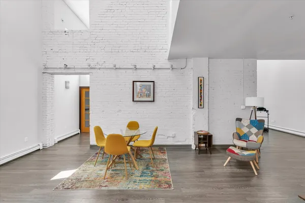 a dining room with furniture and wooden floor