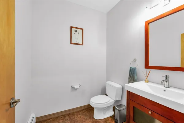 a bathroom with a sink mirror vanity and a toilet