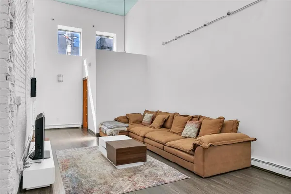 a living room with furniture and a mirror