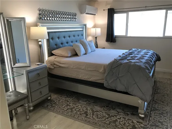 a bedroom with a bed a couch and dresser