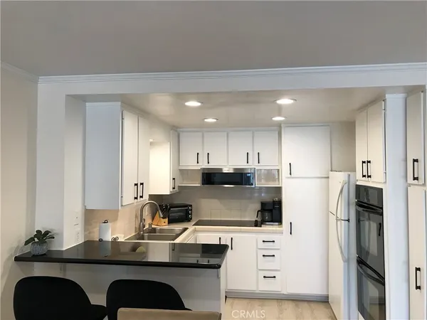 a kitchen with cabinets and a stove
