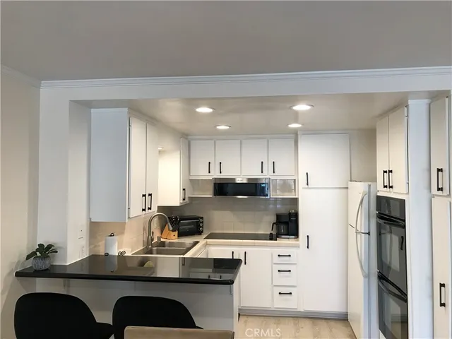 a kitchen with cabinets and a stove