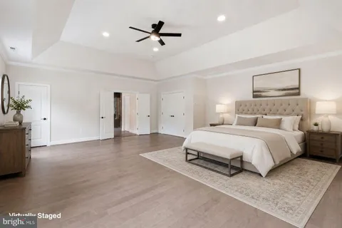 a spacious bedroom with a bed and a chandelier