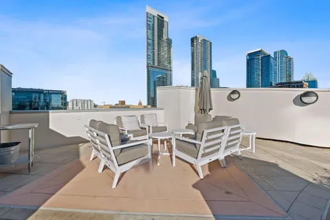 a view of roof with outdoor seating and city view