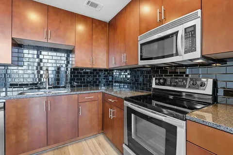 a kitchen that has a sink and a stove