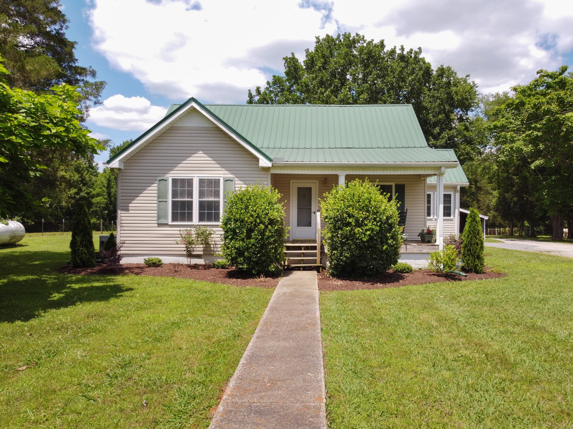a front view of house with yard and green space