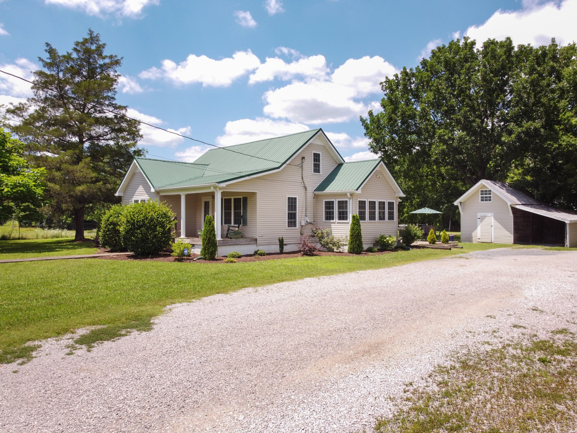 2446 Warner Bridge Road Shelbyville, TN 37160 - Photo 2 of 42 a front view of a house with a yard and garage