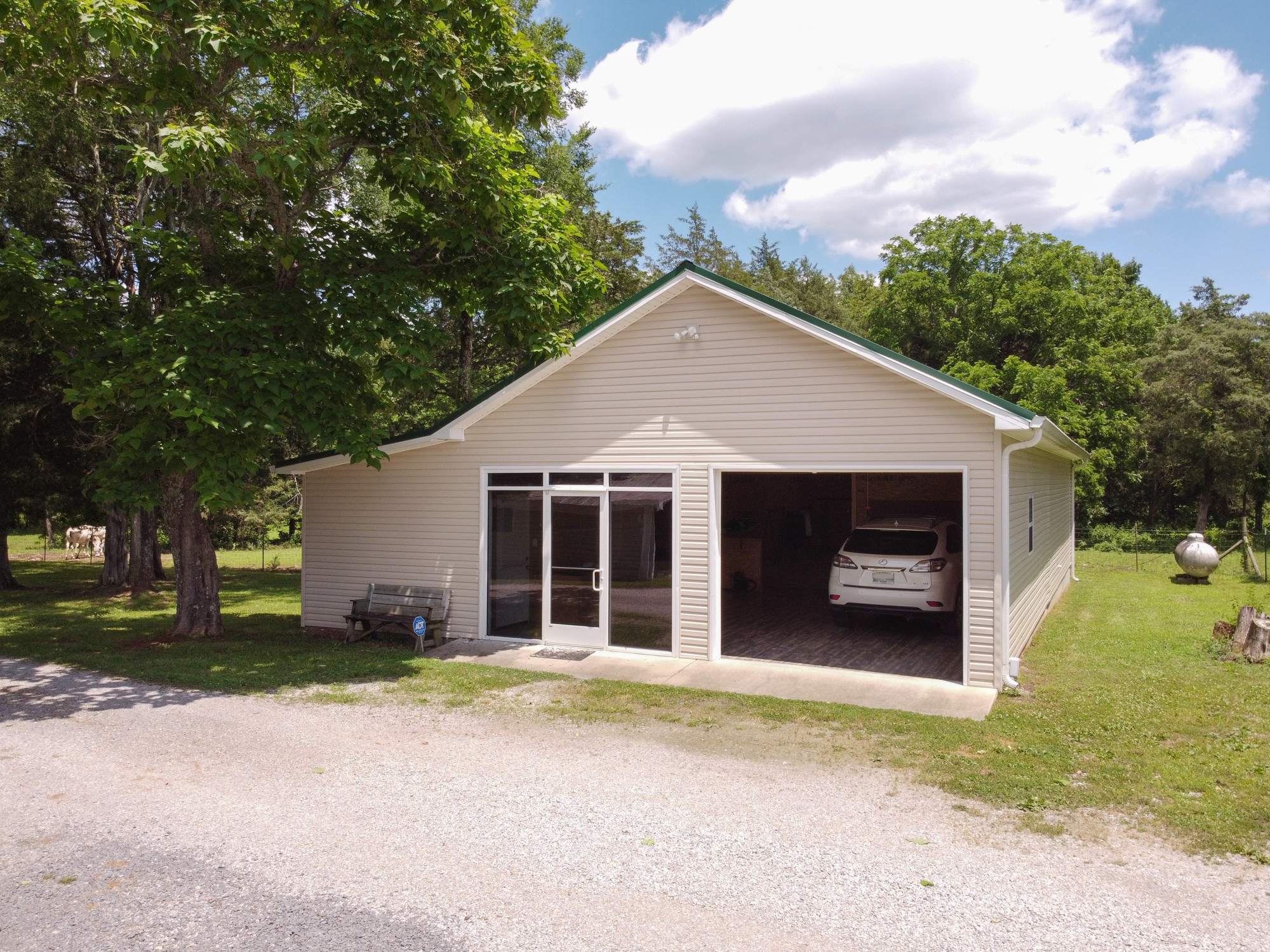 2446 Warner Bridge Road Shelbyville, TN 37160 - Photo 23 of 42 a front view of a house with a yard and garage