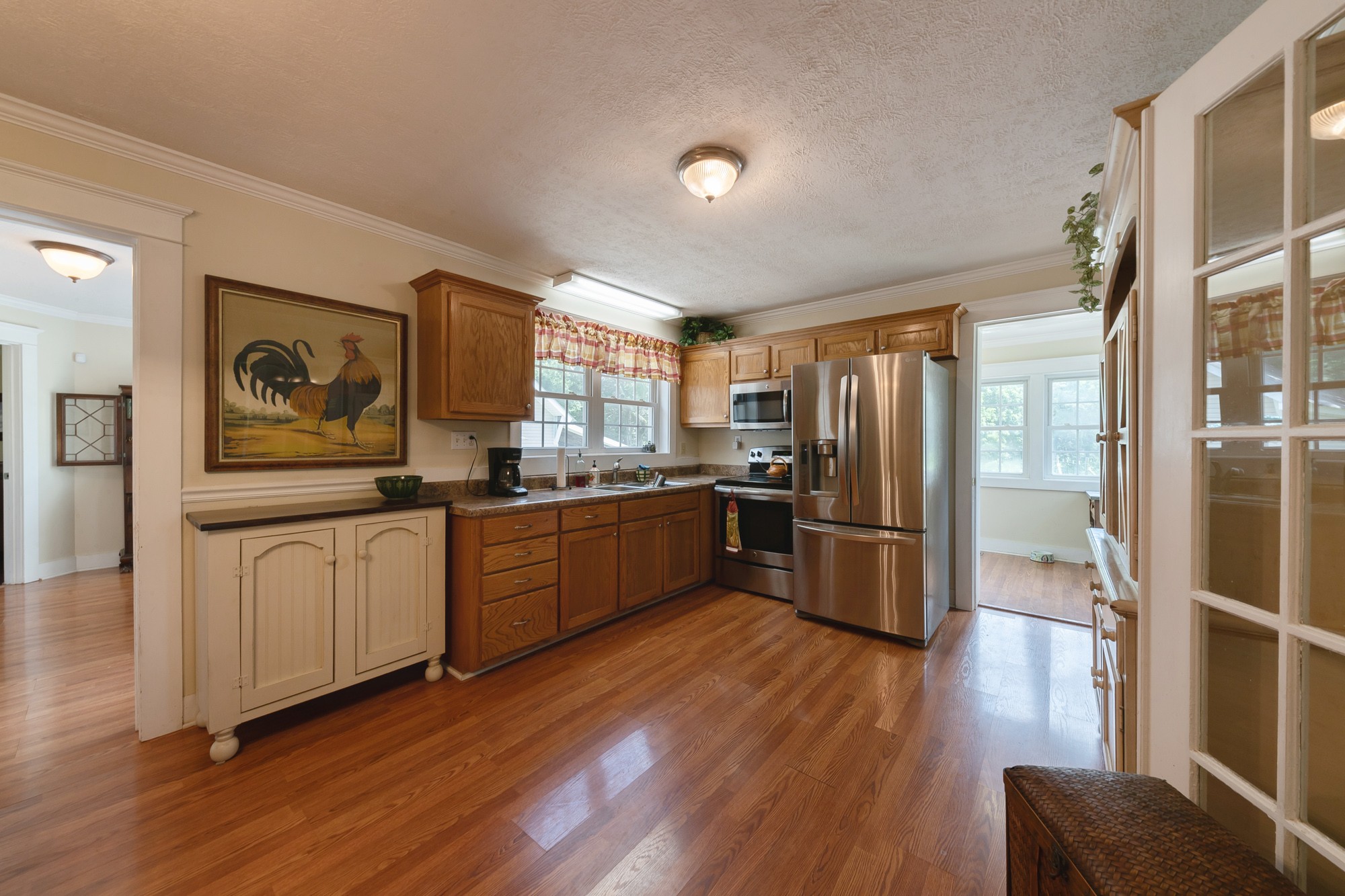 2446 Warner Bridge Road Shelbyville, TN 37160 - Photo 9 of 42 a kitchen with stainless steel appliances a refrigerator a sink dishwasher a stove top oven a refrigerator with wooden floor