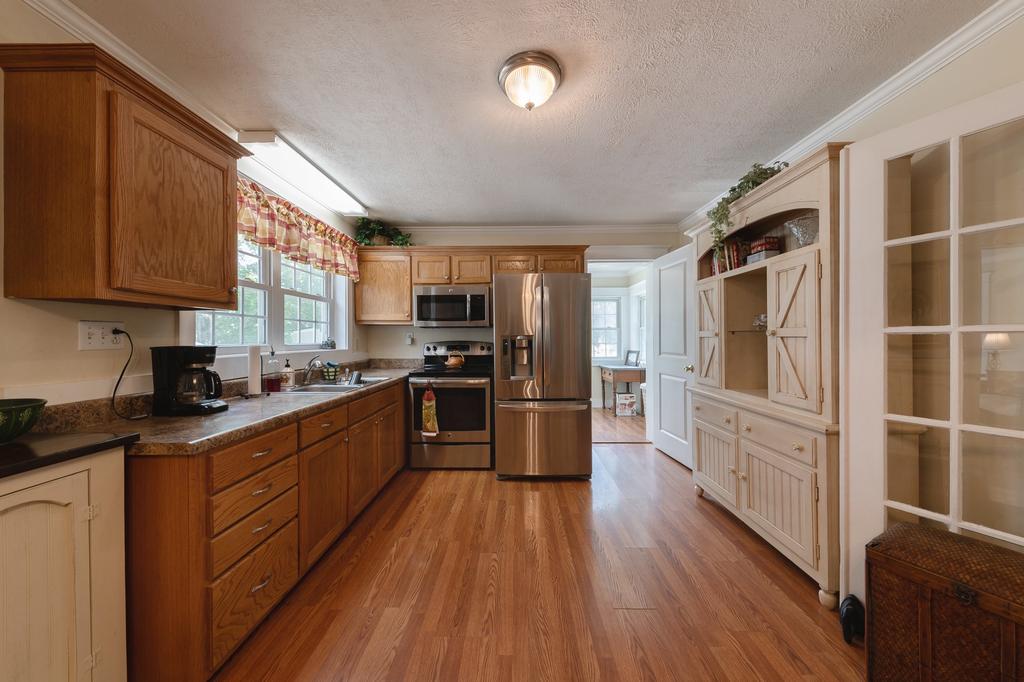 2446 Warner Bridge Road Shelbyville, TN 37160 - Photo 10 of 42 a kitchen with stainless steel appliances a refrigerator a stove top oven and wooden floors