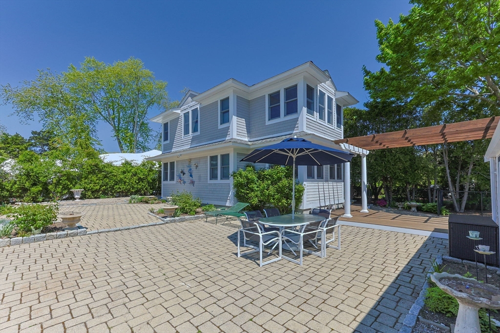 88 Bridge Street Barnstable, MA 02655 - Photo 33 of 36 a wooden bench sitting in front of a building