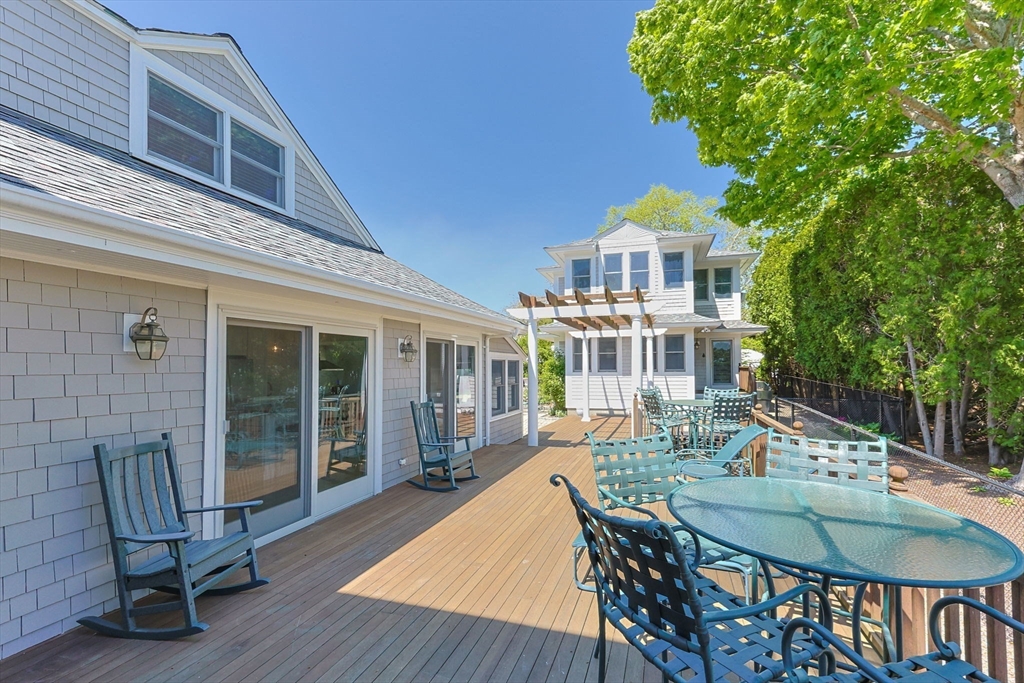 88 Bridge Street Barnstable, MA 02655 - Photo 34 of 36 a front view of a house with a chairs and table in patio