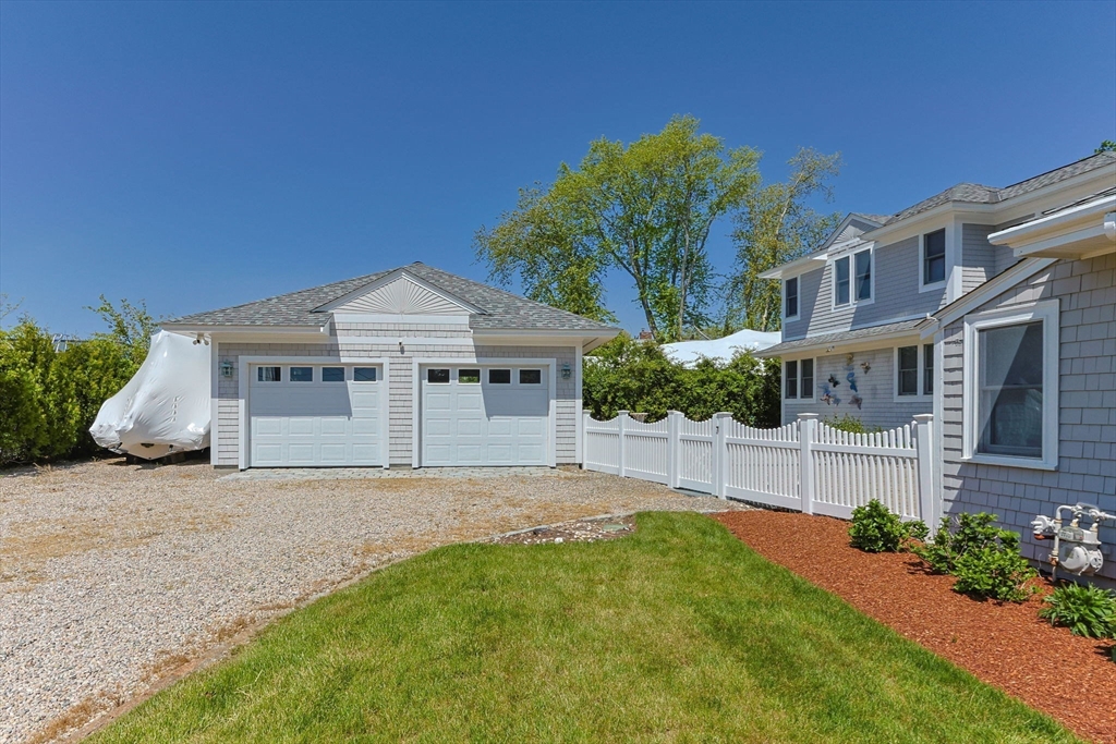 88 Bridge Street Barnstable, MA 02655 - Photo 5 of 36 a front view of a house with a garden and plants