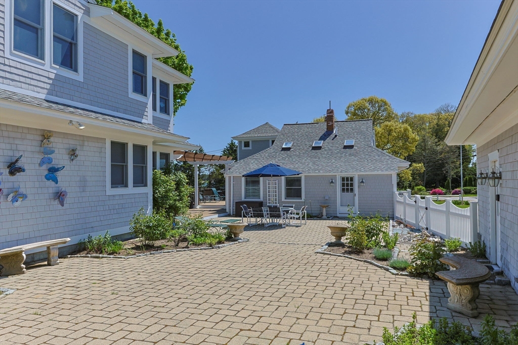 88 Bridge Street Barnstable, MA 02655 - Photo 6 of 36 a front view of a house with yard and outdoor seating