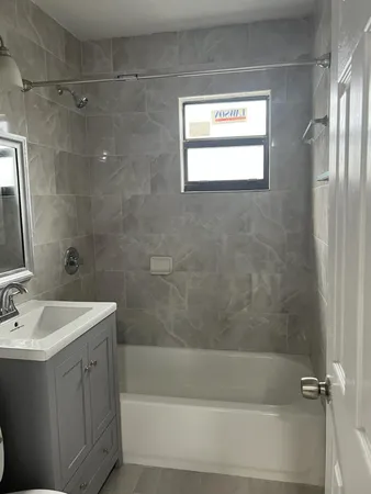 a white bath tub sitting next to a white sink