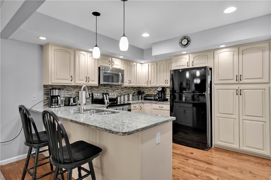 306 Acre Avenue Butler, PA 16001 - Photo 12 of 29 a kitchen with refrigerator a sink and chairs