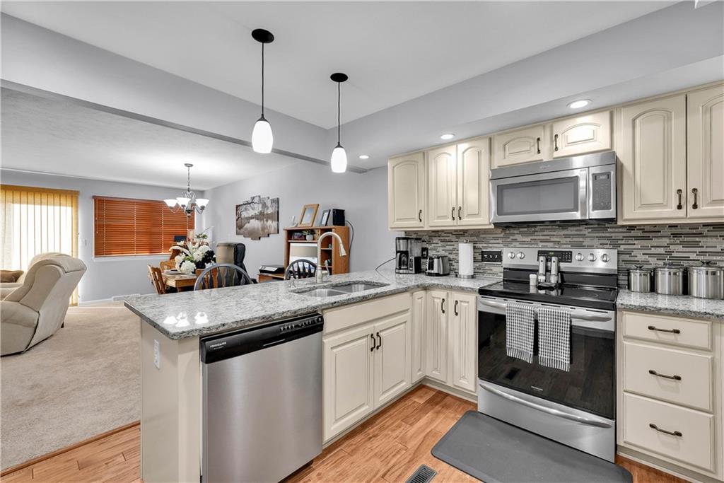 306 Acre Avenue Butler, PA 16001 - Photo 14 of 29 a kitchen with stainless steel appliances granite countertop a stove sink and microwave