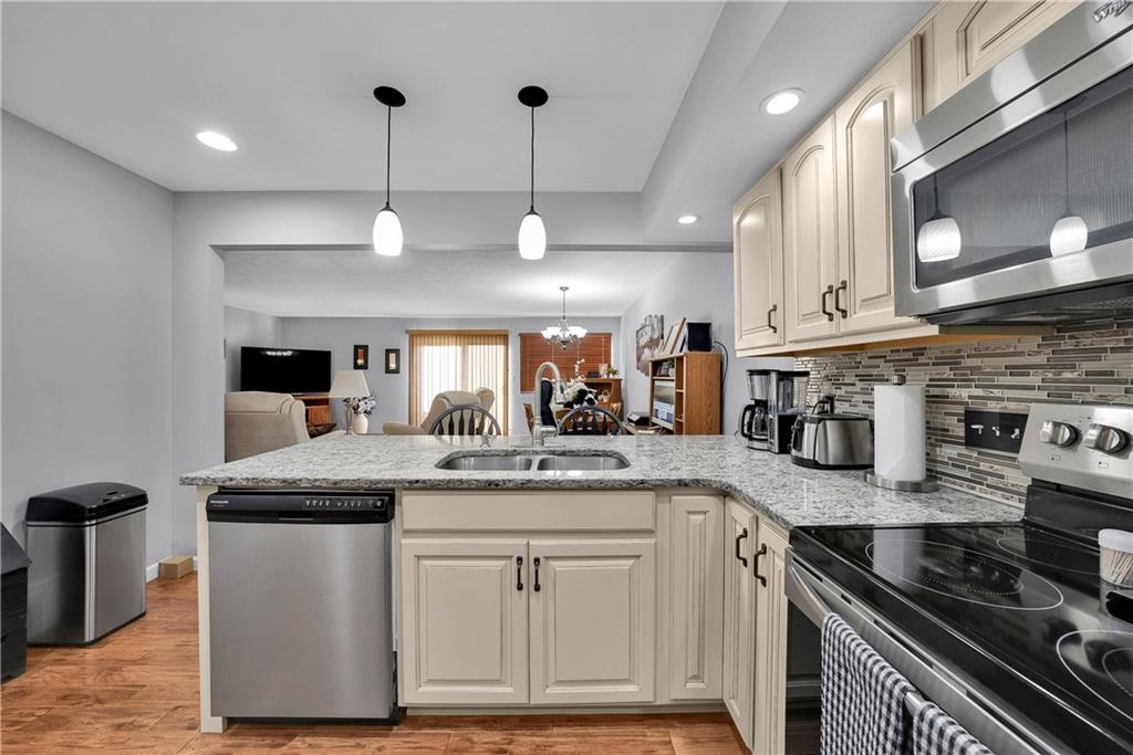 306 Acre Avenue Butler, PA 16001 - Photo 15 of 29 a kitchen with stainless steel appliances granite countertop a sink and a stove