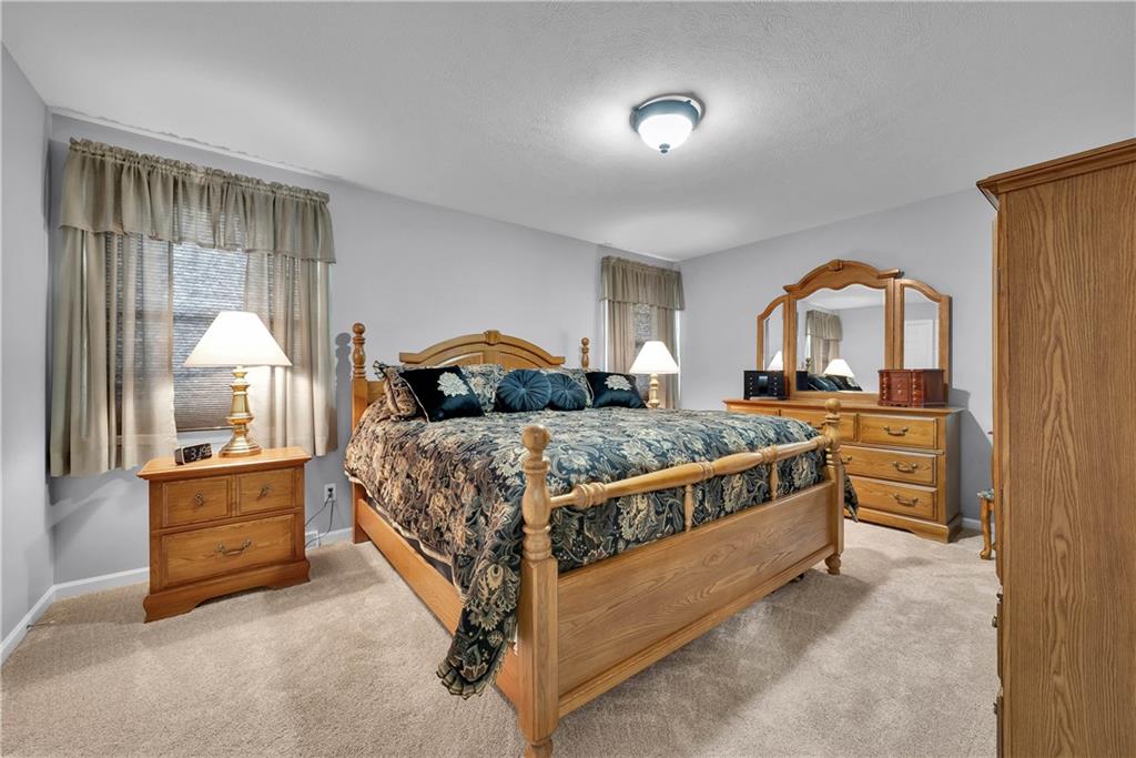 306 Acre Avenue Butler, PA 16001 - Photo 24 of 29 a bedroom with a bed and a mirror on dresser