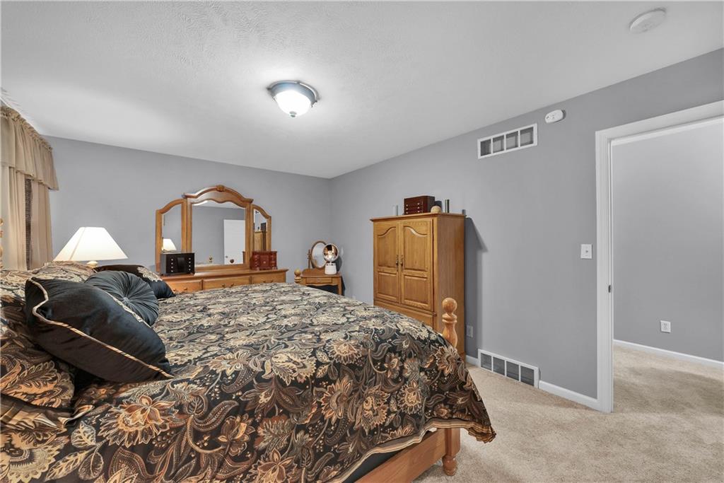 306 Acre Avenue Butler, PA 16001 - Photo 25 of 29 a bedroom with a bed and wooden floor