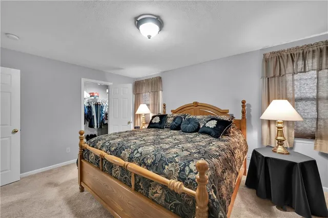 a bedroom with a bed and a lamp