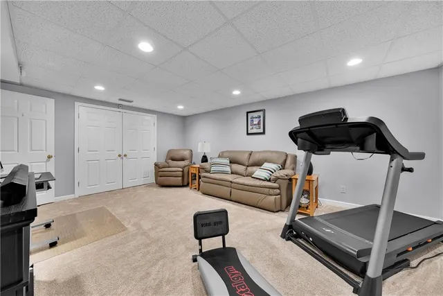 a living room with furniture gym equipment and a view of living room