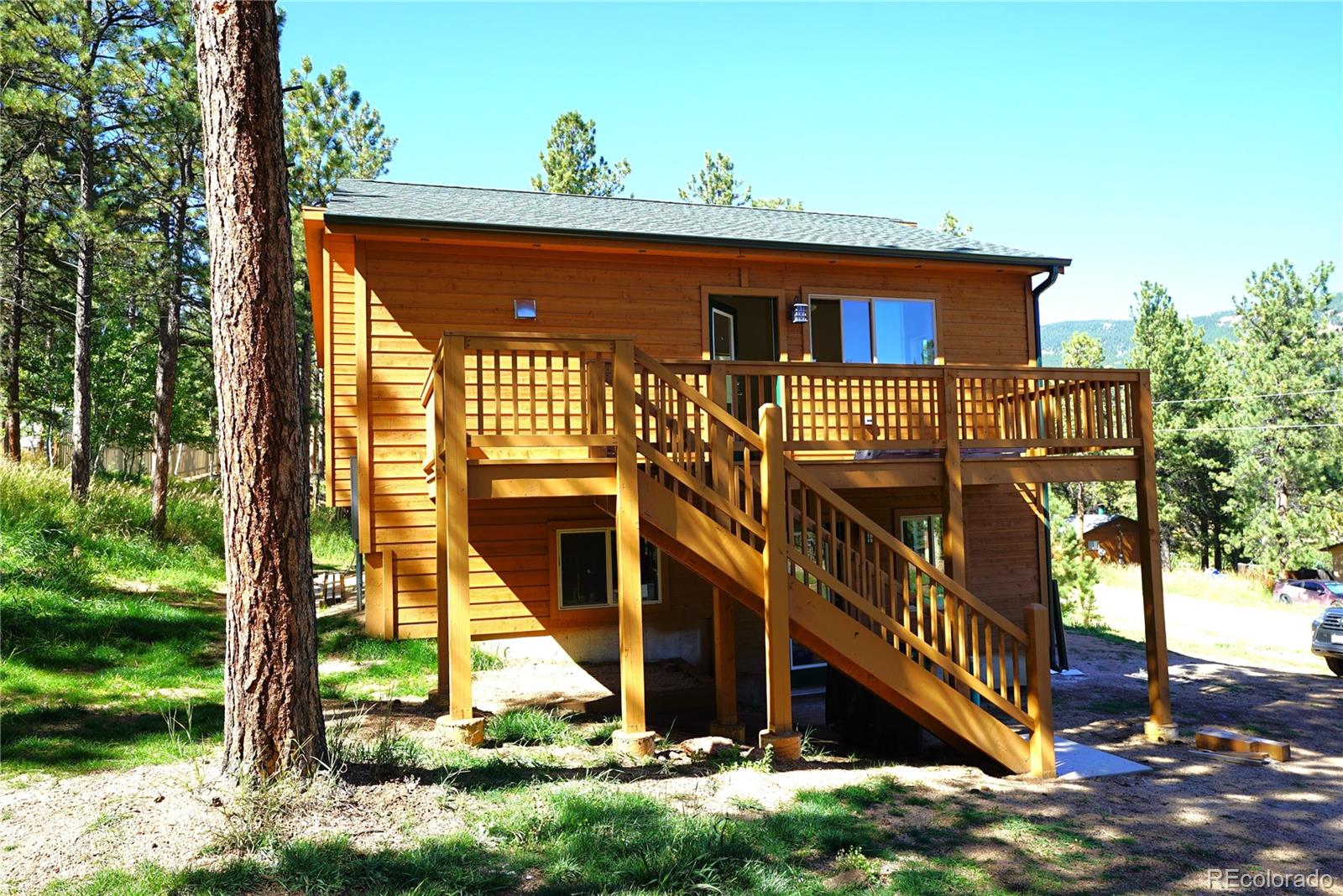 87 Neal Street Bailey, CO 80421 - Photo 2 of 15 a front view of a house with a yard