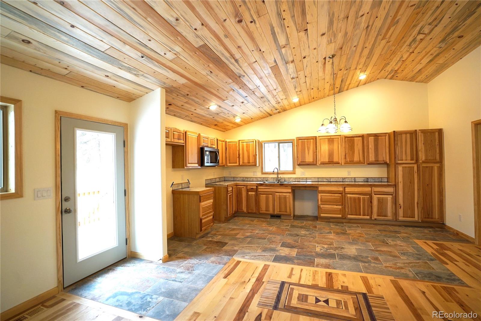 87 Neal Street Bailey, CO 80421 - Photo 3 of 15 a view of a kitchen with kitchen island granite countertop a sink and cabinets