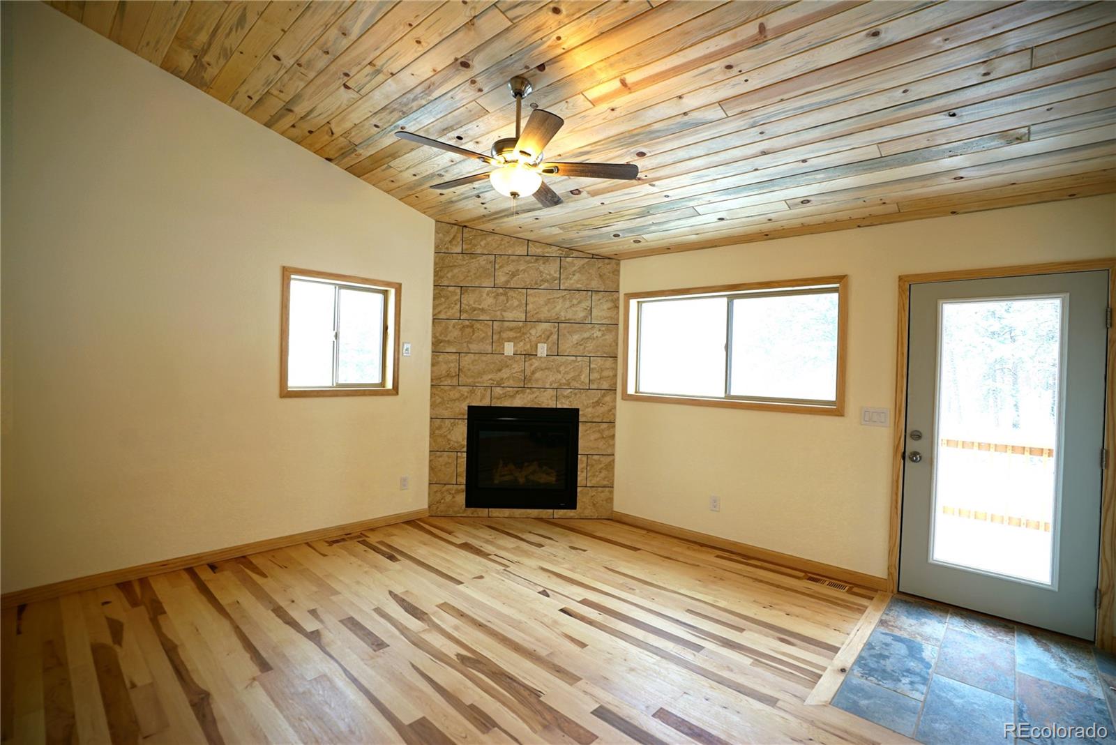 87 Neal Street Bailey, CO 80421 - Photo 6 of 15 a view of empty room with wooden floor and fan