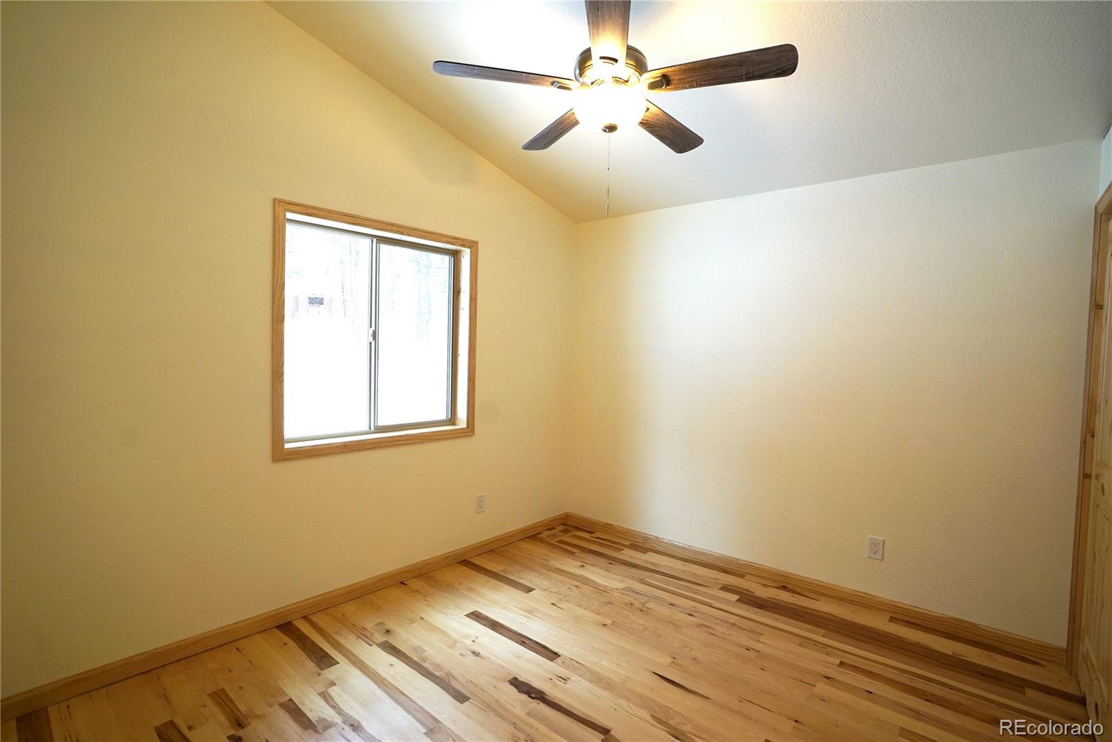 87 Neal Street Bailey, CO 80421 - Photo 7 of 15 a view of empty room with wooden floor and fan