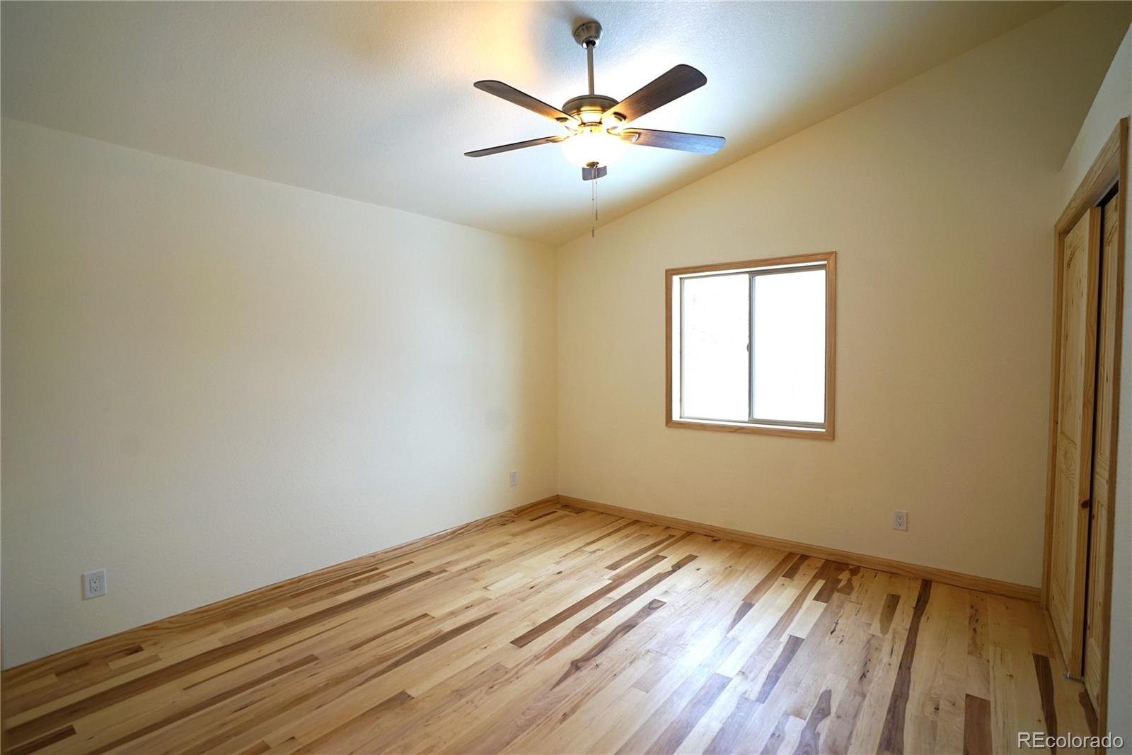 87 Neal Street Bailey, CO 80421 - Photo 8 of 15 wooden floor in an empty room with a window