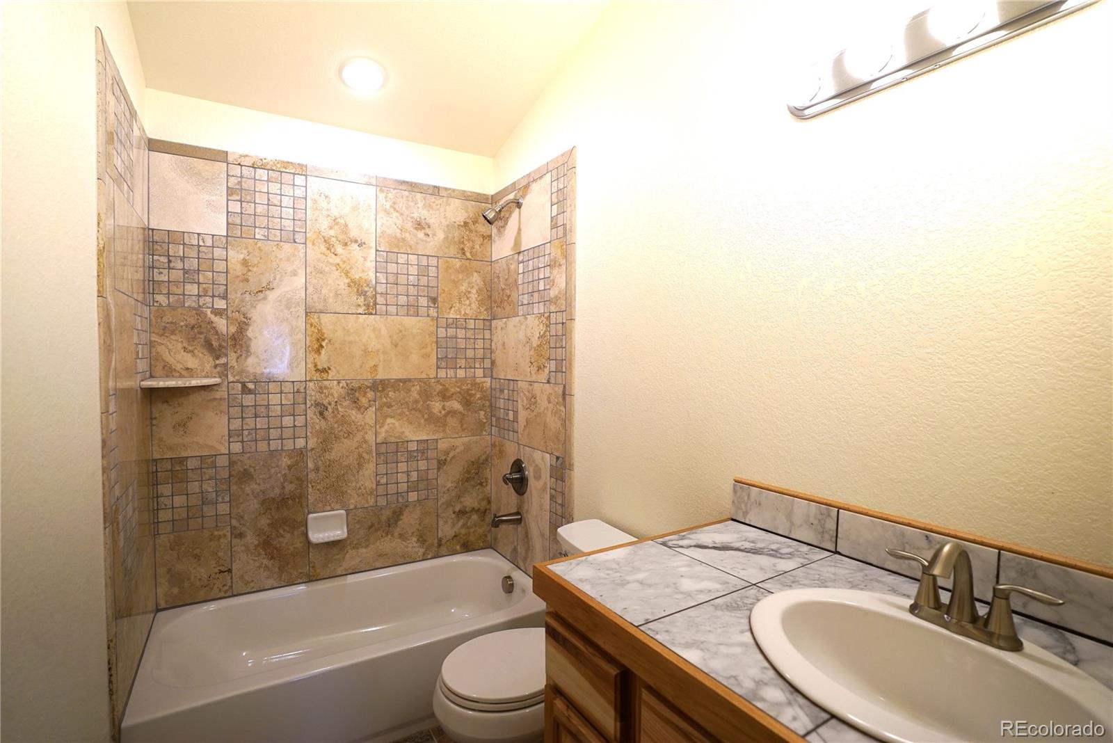 87 Neal Street Bailey, CO 80421 - Photo 9 of 15 a bathroom with a granite countertop sink toilet and shower