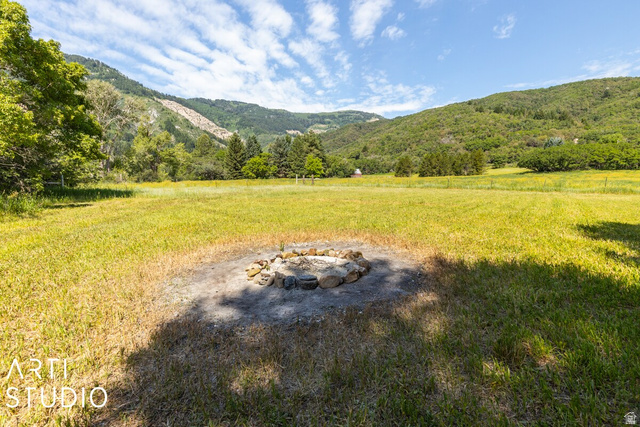 2807 North Ogden Canyon Road Eden, UT 84310 - Photo 66 of 72 Expansive grass field featuring a stone-lined fire pit