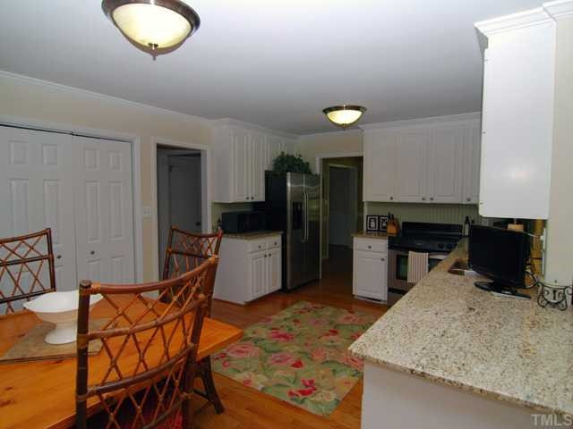 1201 Hunting Ridge Road Raleigh, NC 27615 - Photo 3 of 11 The open kitchen has updated stainless steel appliances and granite countertops. This kitchen also includes a sizable eat-in breakfast area and large double door pantry. Plenty of cabinets add to the storage available in this kitchen. Kitchen