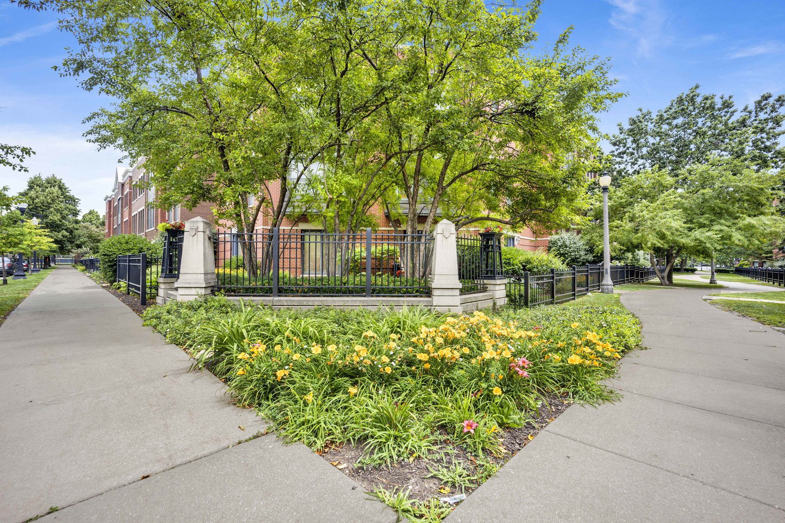 1414 South Halsted Street, Unit 3A Chicago, IL 60607 - Photo 27 of 62 a front view of a house with a yard and fountain in middle