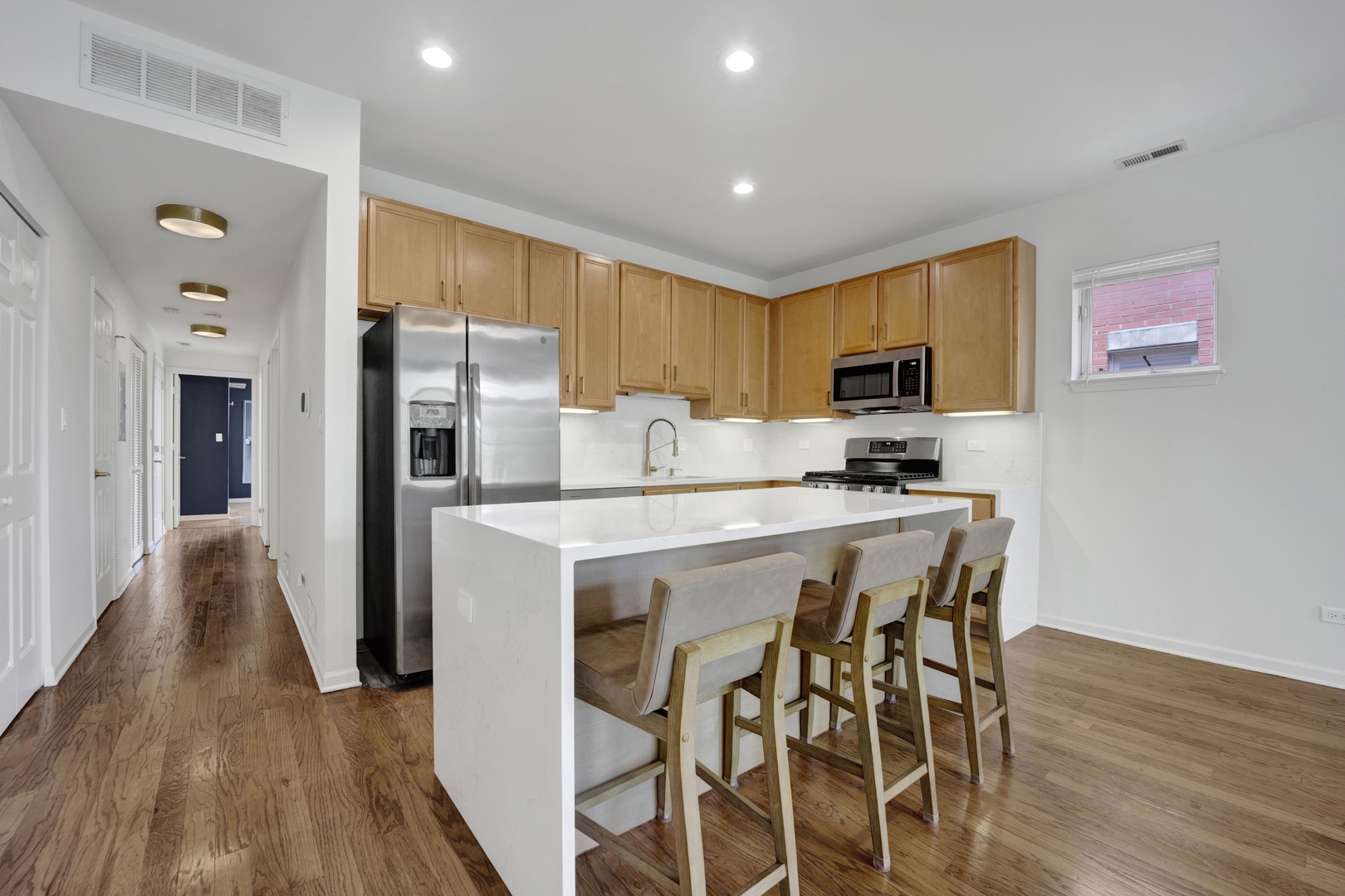 1414 South Halsted Street, Unit 3A Chicago, IL 60607 - Photo 3 of 62 a kitchen with stainless steel appliances a refrigerator a stove a sink dishwasher and a refrigerator with wooden floor