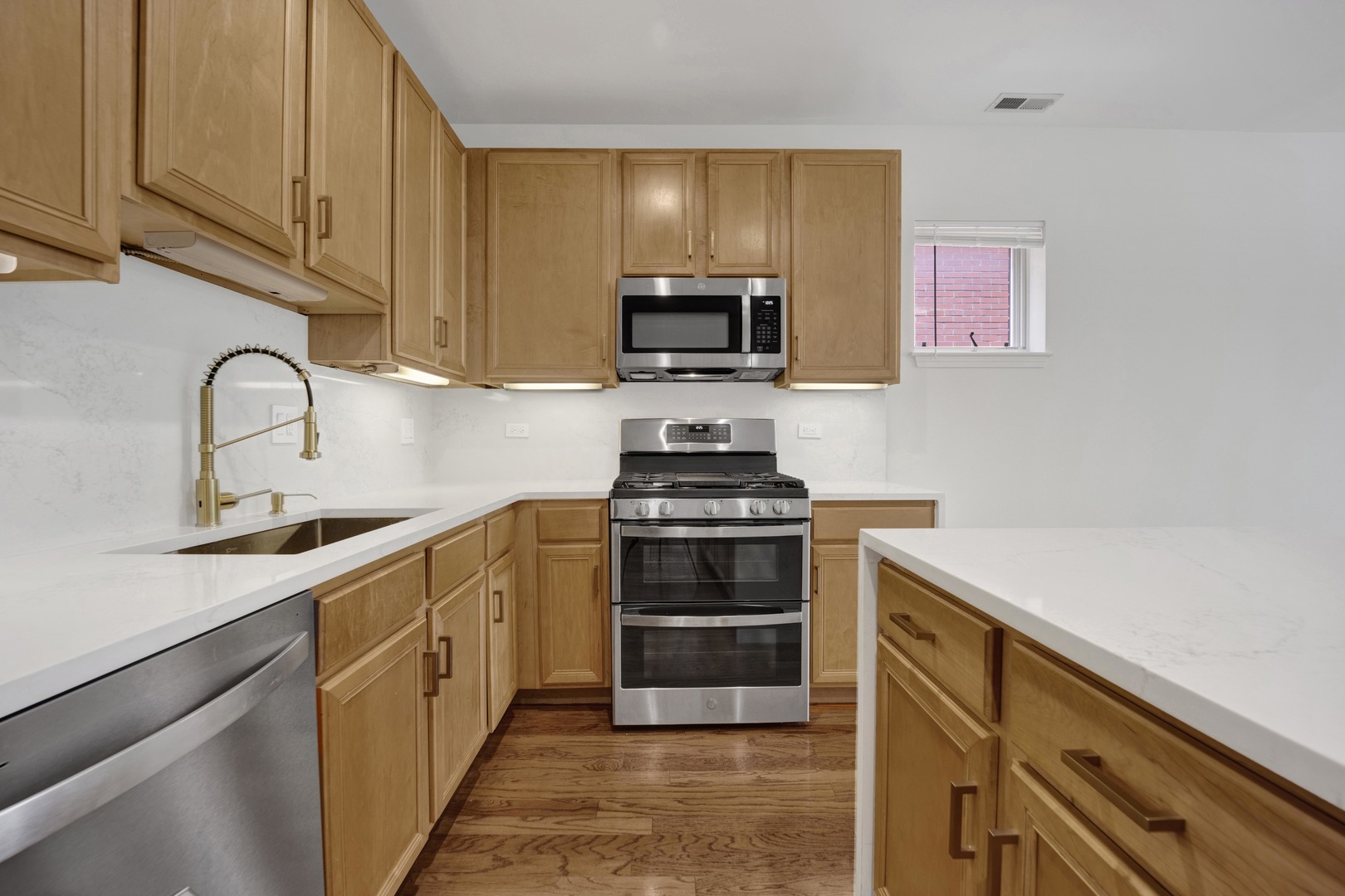 1414 South Halsted Street, Unit 3A Chicago, IL 60607 - Photo 5 of 62 a kitchen with stainless steel appliances a stove microwave and sink