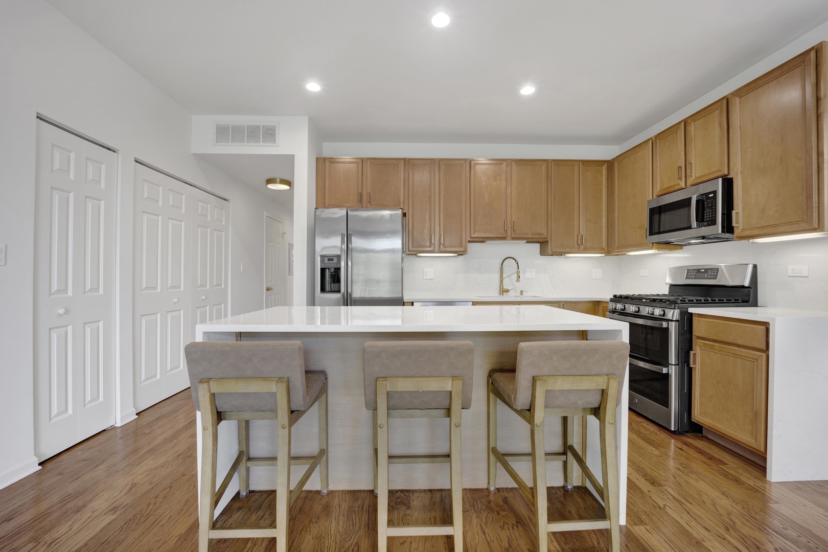 1414 South Halsted Street, Unit 3A Chicago, IL 60607 - Photo 6 of 62 a kitchen with stainless steel appliances granite countertop a table chairs sink refrigerator and microwave