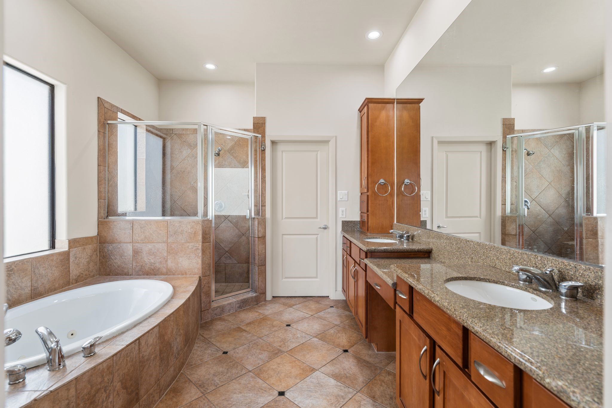 5203 Lillian Street Houston, TX 77007 - Photo 18 of 36 Your primary bath features dual sinks, ample storage and soaking tub/stand alone shower.