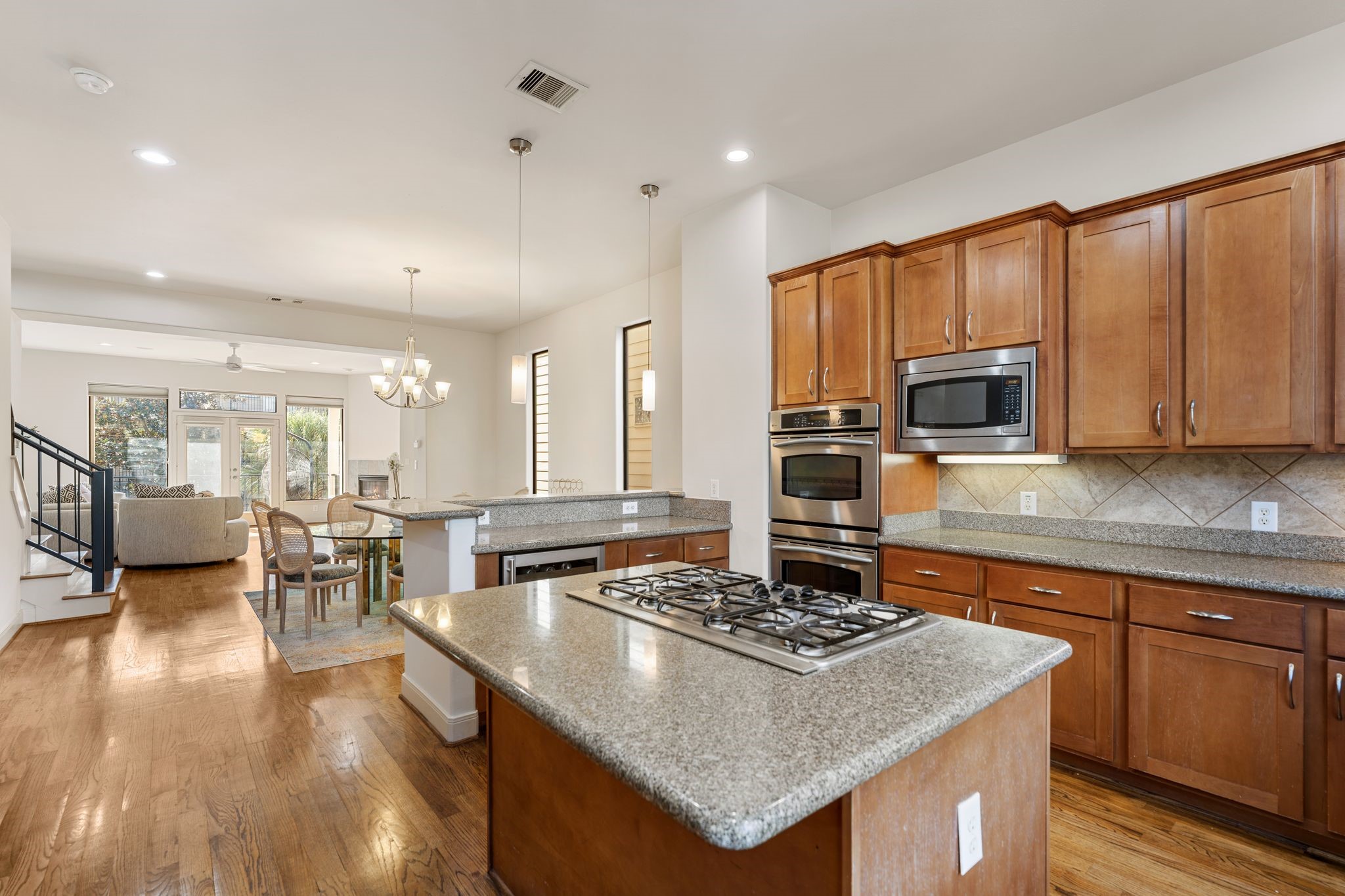 5203 Lillian Street Houston, TX 77007 - Photo 8 of 36 The main living level features a spacious kitchen with ample storage and an abundance of natural light. Tall ceilings and a balcony overlooking the sparkling pool—plus no neighbors across the street—create an open, airy feel perfect for everyday living and entertaining.