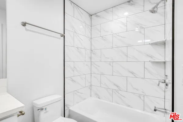 a bathroom with a bathtub and a toilet