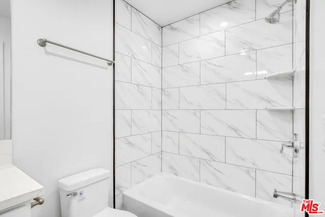 a bathroom with a bathtub and a toilet