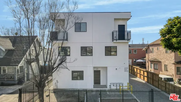 a view of a house with a tree