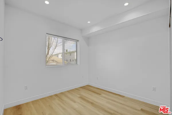 a view of room with wooden floor and fan